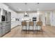 Bright open kitchen features white cabinets, stainless steel appliances, and an island with seating at 3726 Apiary Ln, Johns Island, SC 29455