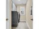 Convenient laundry room features modern washer and dryer, tile floor, and storage cabinets at 3726 Apiary Ln, Johns Island, SC 29455