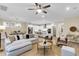 Bright, open-concept living room with a large sofa, modern lighting, and seamless flow to the kitchen at 3726 Apiary Ln, Johns Island, SC 29455