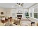 Spacious living room with fireplace, large windows, and plush seating with plenty of natural light at 3726 Apiary Ln, Johns Island, SC 29455