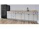 Wet bar featuring gray cabinets, granite countertops, a modern sink, and a mini fridge for entertaining at 3726 Apiary Ln, Johns Island, SC 29455