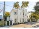 Beautiful three-story home featuring light blue shutters, a balcony, and well-maintained landscaping at 402 Rose Wilder Ln, Mount Pleasant, SC 29464