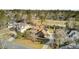 Aerial view showcasing a house with solar panels, a pool, a well-manicured lawn and mature trees at 4162 Club Course Dr, North Charleston, SC 29420