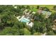 Aerial view showing a community pool and tennis courts nestled among mature trees and landscaping in a neighborhood setting at 4162 Club Course Dr, North Charleston, SC 29420