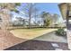 Well-manicured backyard featuring a lush lawn, mature trees, landscaping and privacy fencing at 4162 Club Course Dr, North Charleston, SC 29420