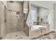 Beautiful bathroom features a glass enclosed shower and soaking tub with decorative tile surround at 4162 Club Course Dr, North Charleston, SC 29420