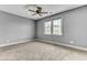 Neutral bedroom featuring a ceiling fan, carpeted floors, and a window bringing in natural light at 4162 Club Course Dr, North Charleston, SC 29420