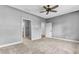 Spacious bedroom with neutral carpet, ceiling fan, and doorways to bathroom and another room at 4162 Club Course Dr, North Charleston, SC 29420