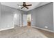 Grey bedroom featuring carpet flooring, a ceiling fan, and access to other rooms through doors at 4162 Club Course Dr, North Charleston, SC 29420