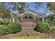 Inviting Coosaw Creek Clubhouse entrance with brick columns, manicured landscaping, and clear signage at 4162 Club Course Dr, North Charleston, SC 29420