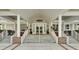 Elegant clubhouse entrance featuring double doors, covered porch, brick stairs and decorative planters at 4162 Club Course Dr, North Charleston, SC 29420