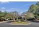 Grand view of the Coosaw Creek Clubhouse entrance with circular driveway and mature trees at 4162 Club Course Dr, North Charleston, SC 29420