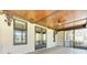 Relaxing covered porch features a wood plank ceiling, ceiling fan and black framed windows at 4162 Club Course Dr, North Charleston, SC 29420