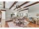 Charming dining room featuring wood beams, hardwood floors, and a decorative rug, providing a cozy atmosphere at 4162 Club Course Dr, North Charleston, SC 29420