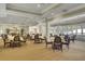 Bright dining room with abundant seating, large windows, and elegant decor creating a welcoming ambiance at 4162 Club Course Dr, North Charleston, SC 29420