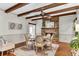 Cozy dining area with wood beams, hardwood floors, and a stone fireplace, offering a warm atmosphere for dining at 4162 Club Course Dr, North Charleston, SC 29420
