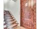 Welcoming entryway features a decorative wooden door and carpeted staircase leading upstairs at 4162 Club Course Dr, North Charleston, SC 29420