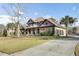This home features a manicured lawn, side-entry three-car garage, American flag, and a blend of stone and stucco at 4162 Club Course Dr, North Charleston, SC 29420