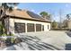 View of the home's three-car garage with dark brown doors, solar panels, and a smooth, sealed concrete surface at 4162 Club Course Dr, North Charleston, SC 29420