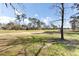 Scenic view of the golf course, showcasing lush green fairways and mature trees in a sunny landscape at 4162 Club Course Dr, North Charleston, SC 29420