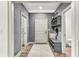 Hallway with storage, a bench, neutral paint, and leading to the bathroom at 4162 Club Course Dr, North Charleston, SC 29420
