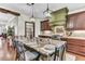 A gourmet kitchen features a large island with granite countertops, pendant lighting, and professional-grade appliances at 4162 Club Course Dr, North Charleston, SC 29420