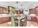 Spacious kitchen boasts custom cabinetry, modern appliances, a large island with seating, and hardwood flooring at 4162 Club Course Dr, North Charleston, SC 29420