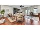 Bright living room boasts hardwood floors, neutral walls, and a stylish bar area, with lots of windows and natural light at 4162 Club Course Dr, North Charleston, SC 29420