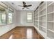 Bright room featuring hardwood floors, large windows, built-in shelves, and a modern ceiling fan at 4162 Club Course Dr, North Charleston, SC 29420