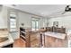 Open floorplan featuring wet bar, bar stool seating, hardwood floors, and lots of natural light at 4162 Club Course Dr, North Charleston, SC 29420