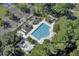 Aerial view of a community pool and seating areas surrounded by lush landscaping and trees in a neighborhood setting at 4162 Club Course Dr, North Charleston, SC 29420