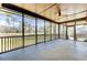 Large screened porch with high ceilings and a view of the backyard and trees at 4162 Club Course Dr, North Charleston, SC 29420