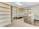 Spacious storage room with multiple shelving units and carpeted floor, offering ample space at 4162 Club Course Dr, North Charleston, SC 29420