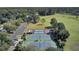 Aerial view of community tennis and sports courts with a parking lot and grassy area nearby, surrounded by trees at 4162 Club Course Dr, North Charleston, SC 29420