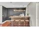 Wet bar features wood counter, tile backsplash, wooden shelving, and seating with barstools at 4162 Club Course Dr, North Charleston, SC 29420