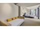 A bedroom featuring both a queen bed and an additional daybed with bright yellow pillows at 487 King St # 201, Charleston, SC 29403
