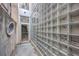 Exterior view of a modern courtyard with a glass block wall and a steel door at 487 King St # 201, Charleston, SC 29403