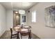 Dining room with modern decor featuring a table with a vase and four chairs at 487 King St # 201, Charleston, SC 29403