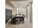 Conference/dining room filled with light from large windows, a black table, and a chalkboard wall at 487 King St # 201, Charleston, SC 29403