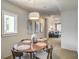 The dining room has modern lighting, art, a wood table, and a window offering views of the outdoors at 487 King St # 201, Charleston, SC 29403