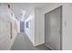 Modern hallway features clean white walls, neutral carpet, and metal apartment doors at 487 King St # 201, Charleston, SC 29403
