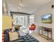 A stylish gray sectional couch with bright pillows in a living room setting and modern lighting at 487 King St # 201, Charleston, SC 29403