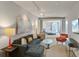 Open living room showcasing a comfortable gray sectional couch, with an adjoined bedroom at 487 King St # 201, Charleston, SC 29403
