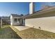 An exterior shot of the home shows a yard, patio, and chimney under a clear blue sky at 501 Hedge Way, Summerville, SC 29486