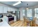 Bright kitchen with stainless steel appliances, a dining area, and ample cabinet space, making it perfect for Gathering meals at 501 Hedge Way, Summerville, SC 29486