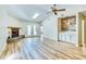 Spacious living room with a cozy fireplace, vaulted ceilings, wood floors, and a stylish built-in bar area at 501 Hedge Way, Summerville, SC 29486
