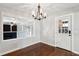 Open dining room featuring hardwood floors, decorative lighting, and easy access to the backyard at 5520 Gale St, North Charleston, SC 29406