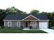 Charming home featuring wood and stone accents, a cozy porch, and an attached garage at 5811 Octavia Ave, Ravenel, SC 29470