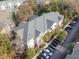 Aerial view of a residential building surrounded by lush greenery and ample parking at 600 Bucksley Ln # 305, Charleston, SC 29492