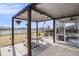 Back patio area featuring a pergola, picnic table, and view of a nearby lake at 624 Sienna Way, Summerville, SC 29486